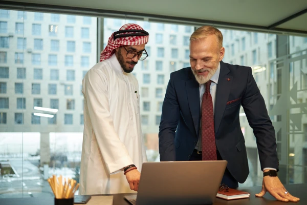 biracial-entrepreneurs-using-laptop-office
